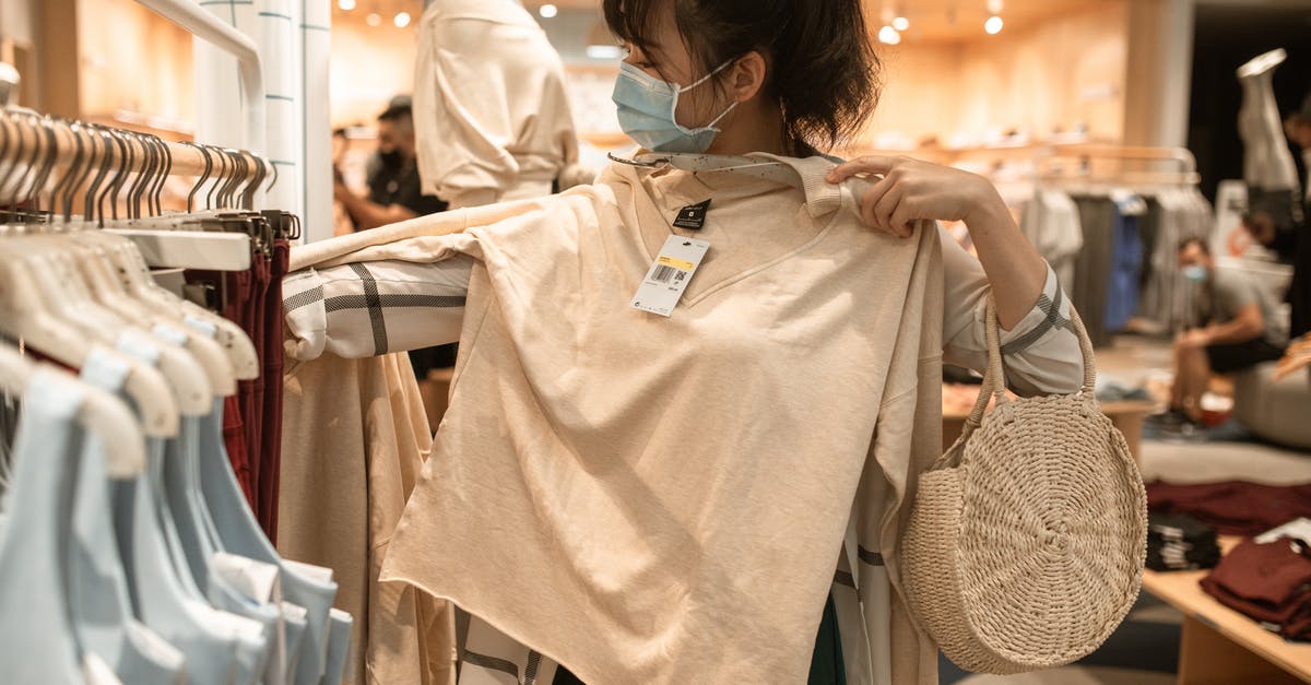 Measuring my options to reach the SF airport - Woman Measuring The Length of A Beige Long Sleeve Shirt Measuring my options to reach the SF airport - Woman Measuring The Length of A Beige Long Sleeve Shirt
