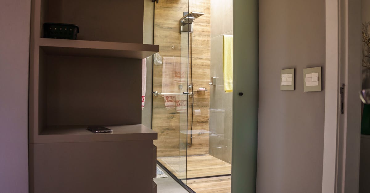 Mexican visa for Finnish residence permit holder - Interior of modern restroom with glass walls of shower cabin with switches on walls and a towel on holder Mexican visa for Finnish residence permit holder - Interior of modern restroom with glass walls of shower cabin with switches on walls and a towel on holder