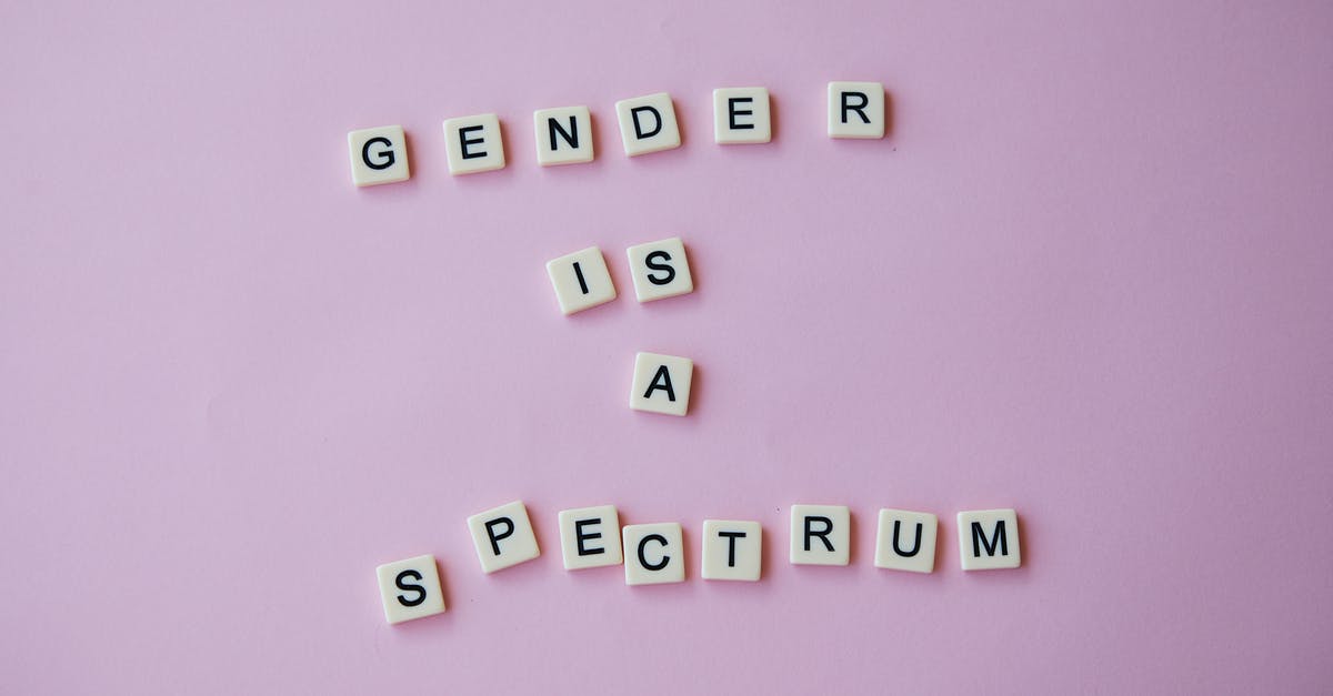Minor consent letter with multiple citizenships - From above of composition made of letters with inscription Gender is a spectrum placed on pink background in studio Minor consent letter with multiple citizenships - From above of composition made of letters with inscription Gender is a spectrum placed on pink background in studio