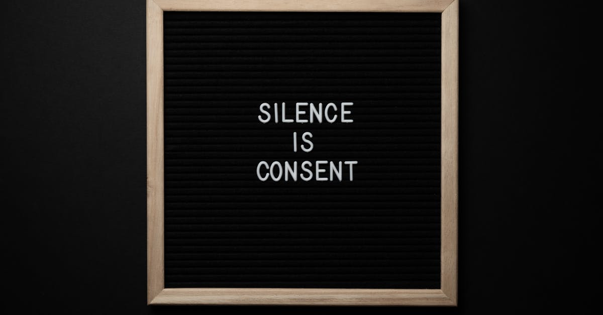 Minor consent letter with multiple citizenships - From above blackboard with written phrase SILENCE IS CONSENT on center on black background Minor consent letter with multiple citizenships - From above blackboard with written phrase SILENCE IS CONSENT on center on black background