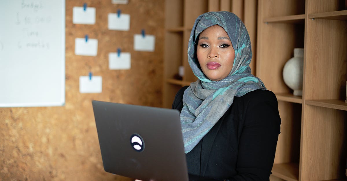 Mobile and mobile internet provider Turkey - Woman in Blue Hijab Using Macbook