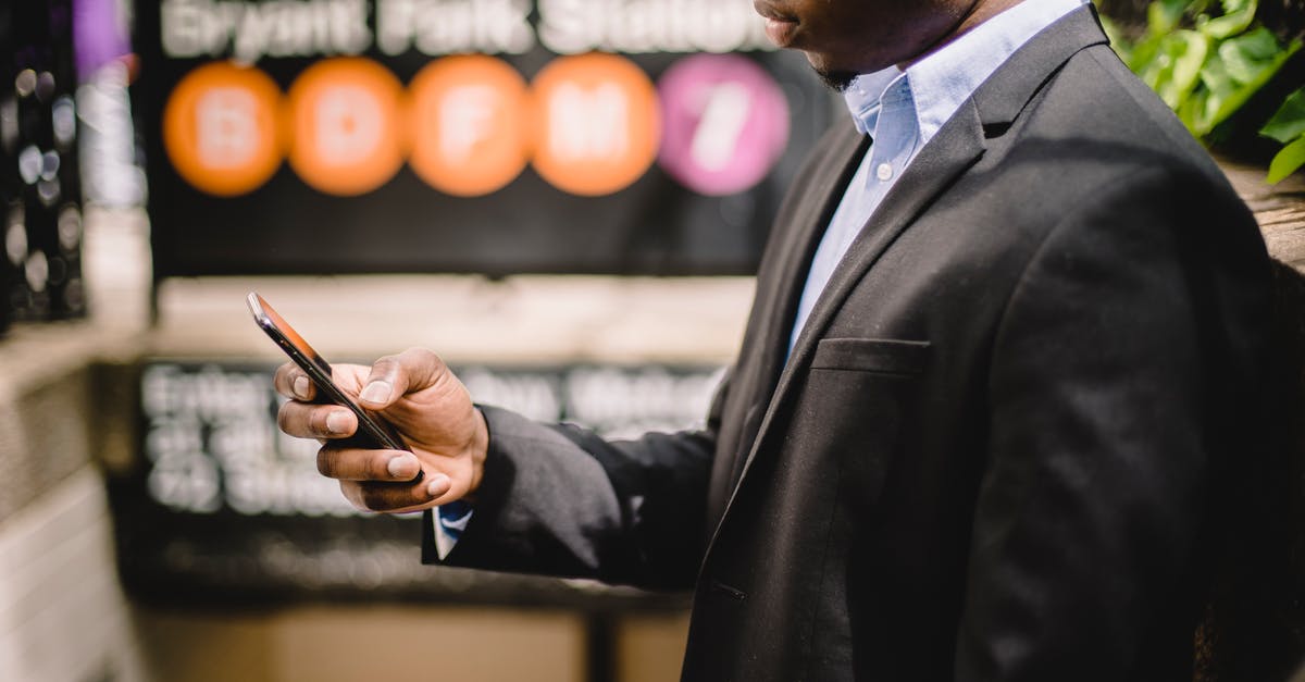 Mobile internet in New York City - African American office employee using cellhone on street Mobile internet in New York City - African American office employee using cellhone on street