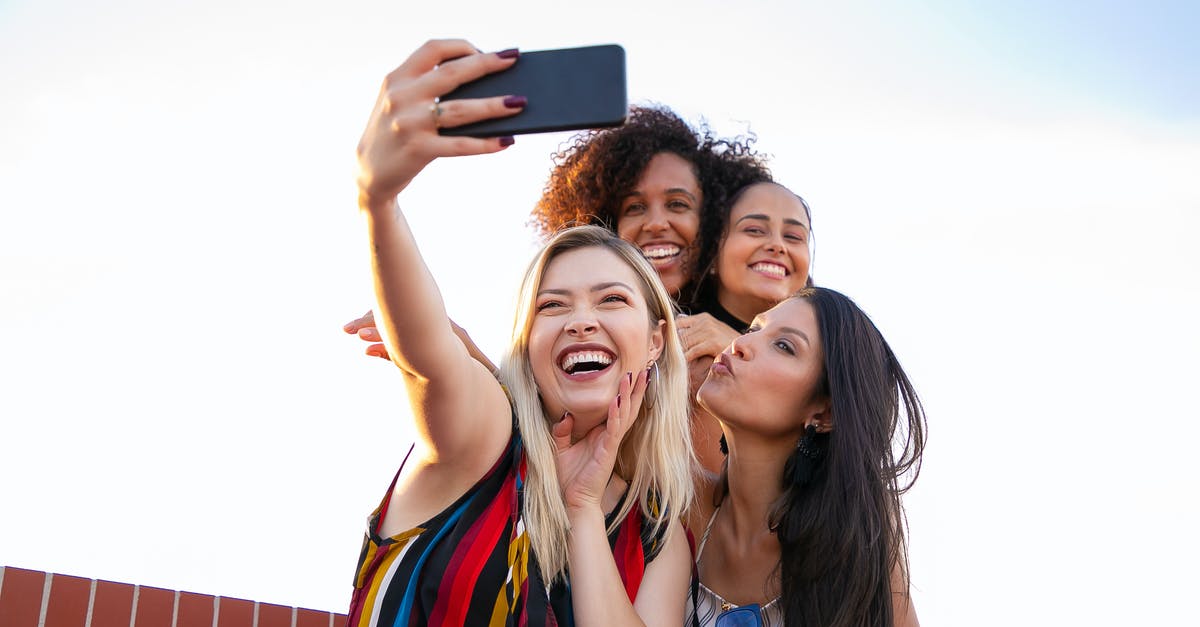 Mobile Roaming Charges in Europe - have they been abolished yet? - Cheerful multiethnic girlfriends taking selfie on smartphone on sunny day Mobile Roaming Charges in Europe - have they been abolished yet? - Cheerful multiethnic girlfriends taking selfie on smartphone on sunny day