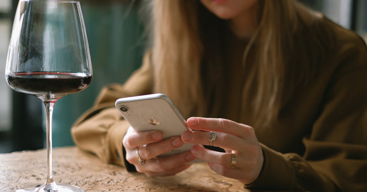 Mobile Wifi Rental in Turkey? - Woman Sitting with a Glass of Wine Scrolling Through Her Phone Mobile Wifi Rental in Turkey? - Woman Sitting with a Glass of Wine Scrolling Through Her Phone