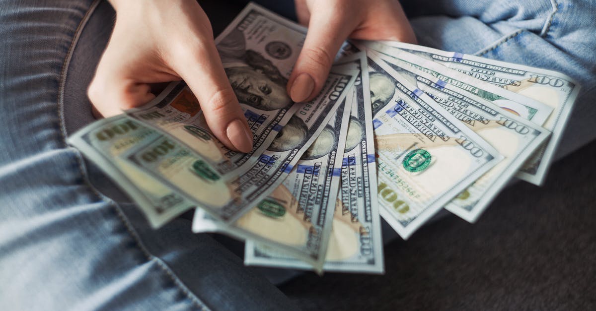 Money exchange in Romania - Person Holding 100 Us Dollar Banknotes Money exchange in Romania - Person Holding 100 Us Dollar Banknotes