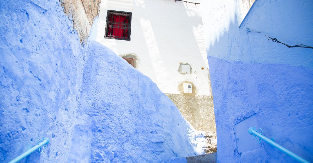 Morocco for an Indian citizen with an EU resident permit - Colorful steps with railings between painted blue walls leading to aged stone residential building on sunny street in old town Morocco for an Indian citizen with an EU resident permit - Colorful steps with railings between painted blue walls leading to aged stone residential building on sunny street in old town