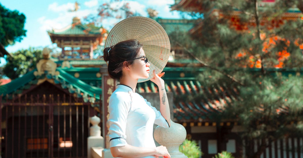 most popular rides at disneyland tokyo - Concentrated young Japanese woman standing by Sensoji temple while having rest in street most popular rides at disneyland tokyo - Concentrated young Japanese woman standing by Sensoji temple while having rest in street