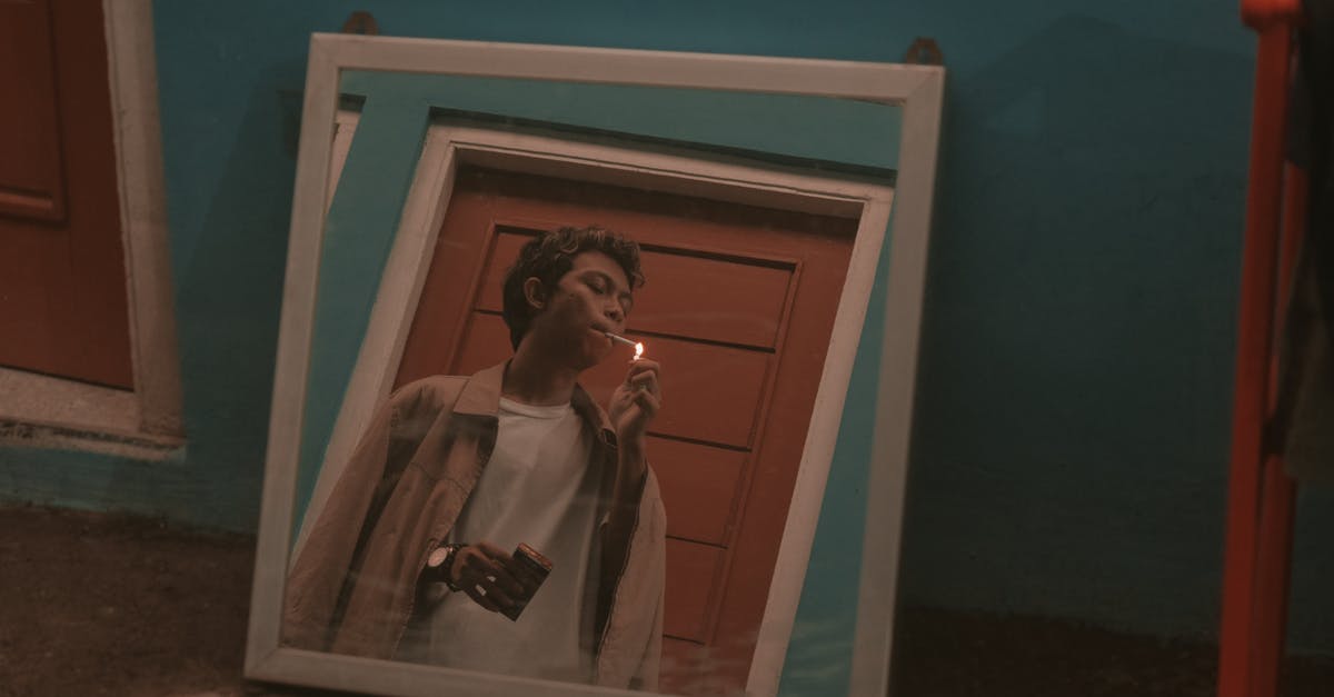 Moved from room after bad insect bite, but what about the next guy? [closed] - Square mirror placed on floor in room and reflecting young rebellious Asian guy in stylish outfit smoking cigarette near door
