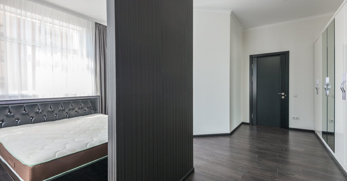 Multi-bedroom or separate bedroom/living room areas at Orlando theme parks? - Interior of modern white apartment with comfortable furniture and soft bed with wooden parquet in daylight