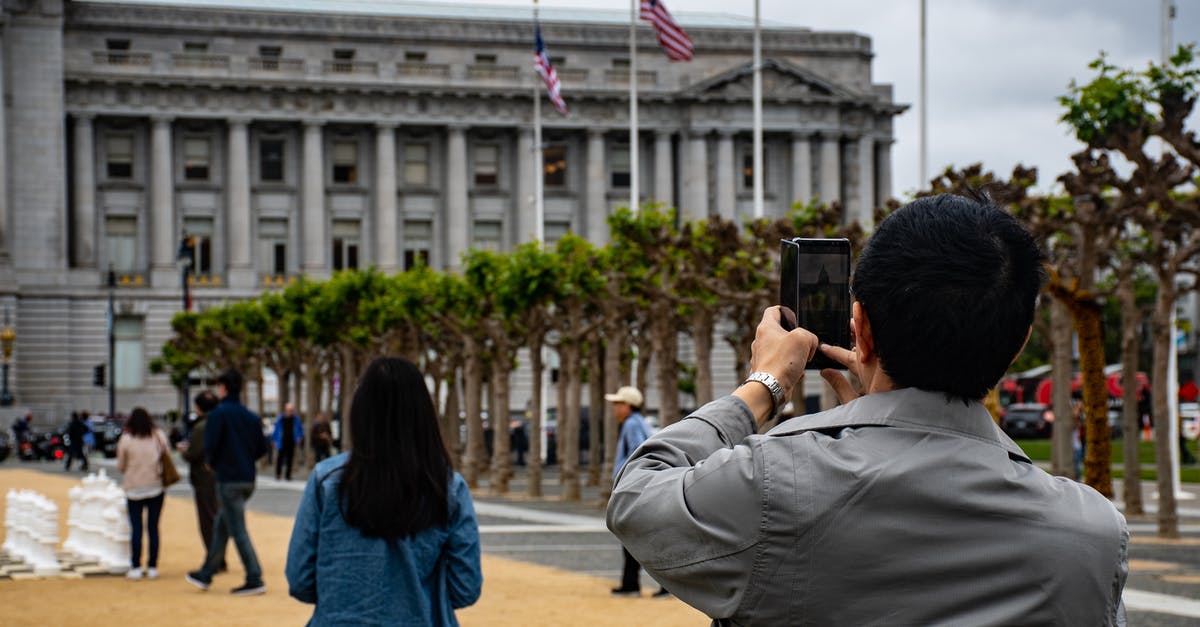 Multiday parking in San Francisco - Man Using Smartphone to Capture Photo Multiday parking in San Francisco - Man Using Smartphone to Capture Photo