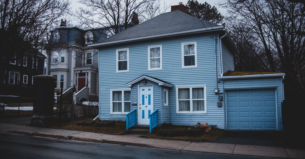 Multiple Entry into Korea - Old residential house trimmed with light blue siding and garage Multiple Entry into Korea - Old residential house trimmed with light blue siding and garage