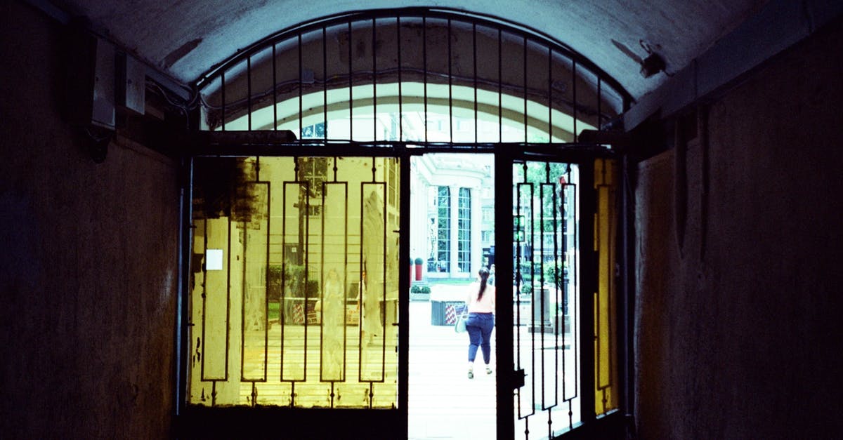 Multiple Entry schengen visa second trip - Half opened gate with glass windows of old passage leading to city street in daylight Multiple Entry schengen visa second trip - Half opened gate with glass windows of old passage leading to city street in daylight