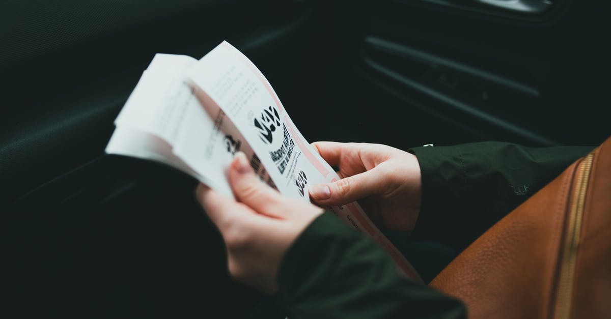 Multiple-Day Tickets in Amsterdam - Person Holding White Plastic Pack Multiple-Day Tickets in Amsterdam - Person Holding White Plastic Pack