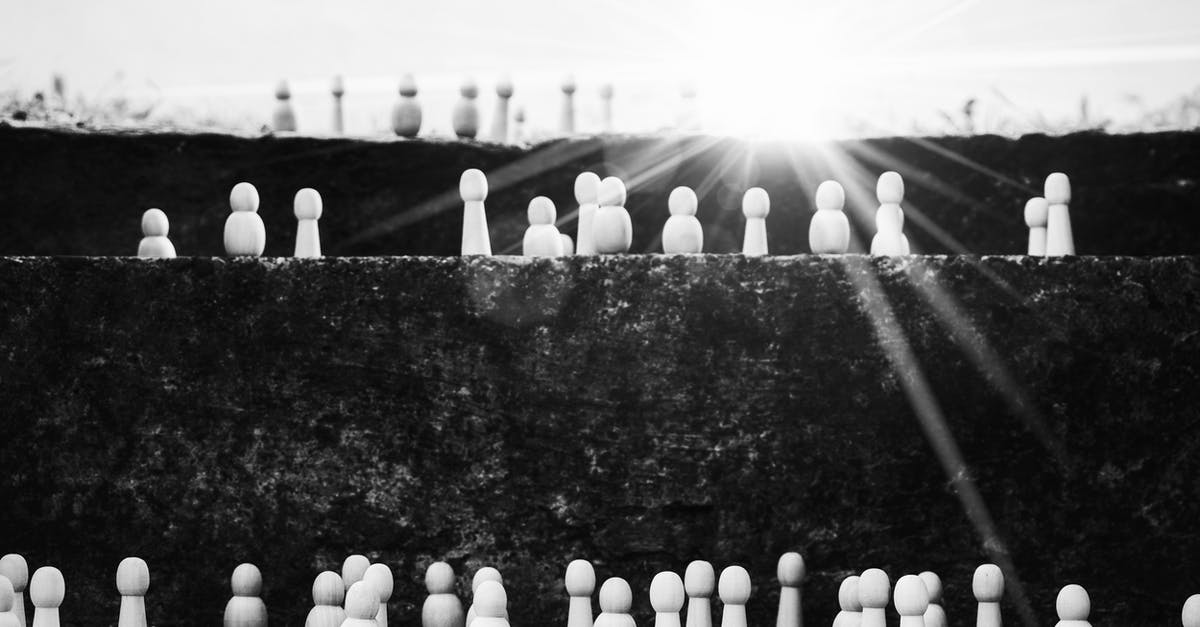 Munich - how can I quickly figure out which station belongs to what ring? - Black and white heap of wooden figurines placed on stairs illustrating social mobility and hierarchy on street with bright sunlight