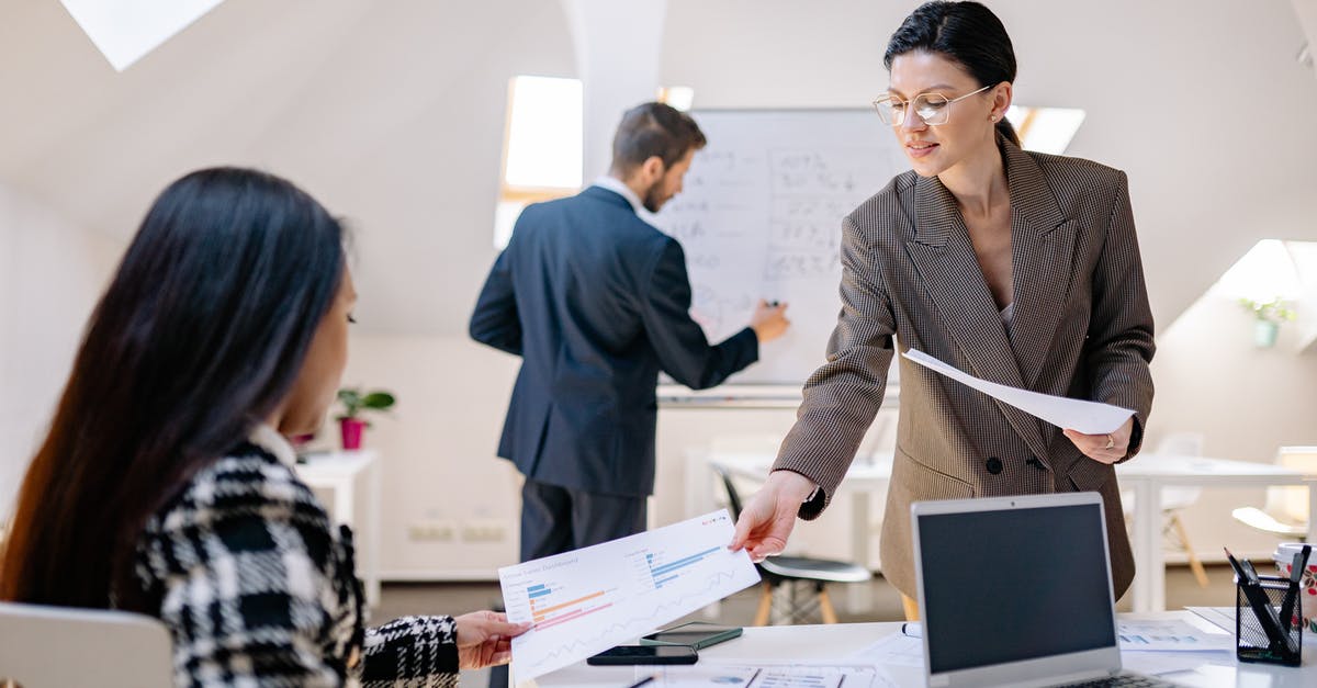 Must hearing aids be taken off when passing through security? - Woman Passing Paper to the Person Sitting Must hearing aids be taken off when passing through security? - Woman Passing Paper to the Person Sitting