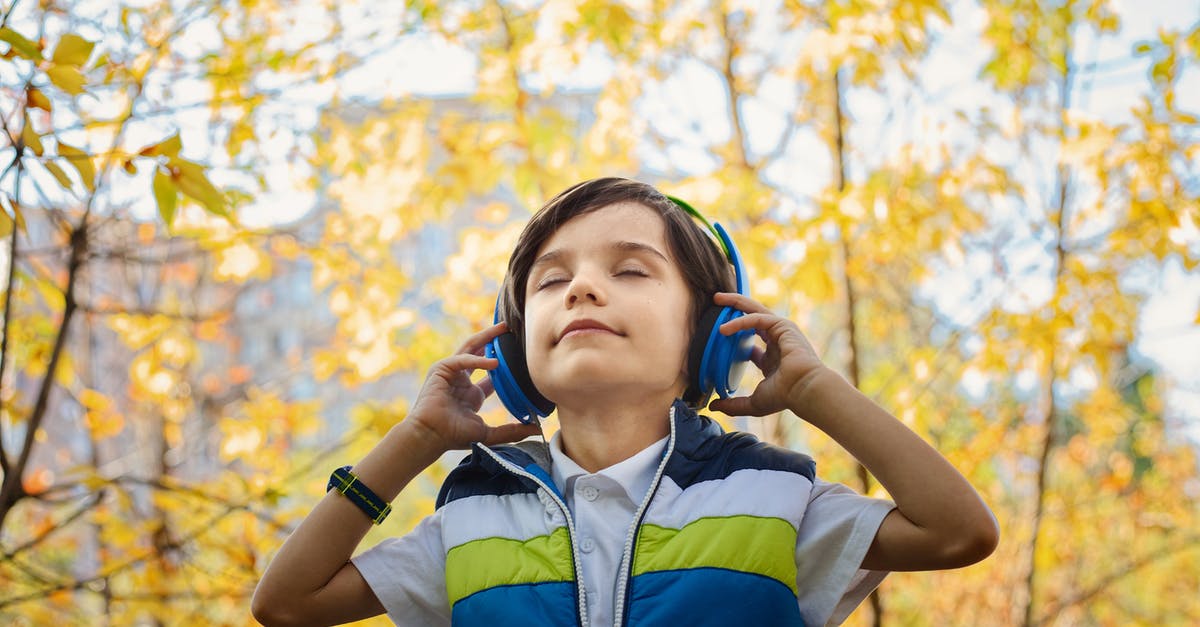 Must hearing aids be taken off when passing through security? - Photo of a Boy Listening in Headphones Must hearing aids be taken off when passing through security? - Photo of a Boy Listening in Headphones