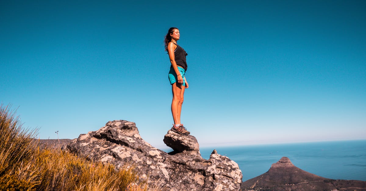 Must I provide proof of onward travel when entering South Africa? - Woman in Black Top and Blue Shorts on Stone Under Blue Sky Must I provide proof of onward travel when entering South Africa? - Woman in Black Top and Blue Shorts on Stone Under Blue Sky