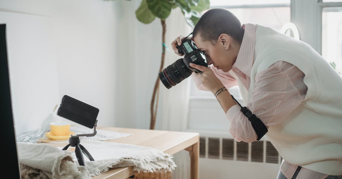 Must I use a Mobile Passport receipt if I create one? - Side view focused female photographer in casual wear taking photo on modern photo camera of smartphone tripod placed on table in light studio Must I use a Mobile Passport receipt if I create one? - Side view focused female photographer in casual wear taking photo on modern photo camera of smartphone tripod placed on table in light studio