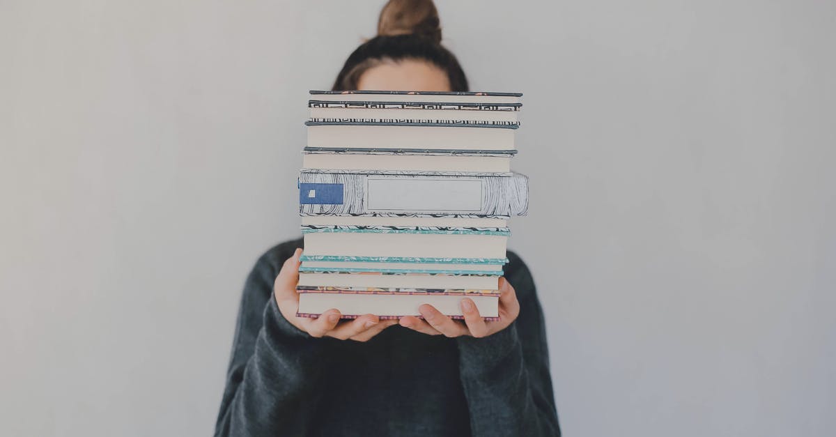 My face in my Japan visa is different because of my wisdom tooth extraction - Anonymous woman with pile of books