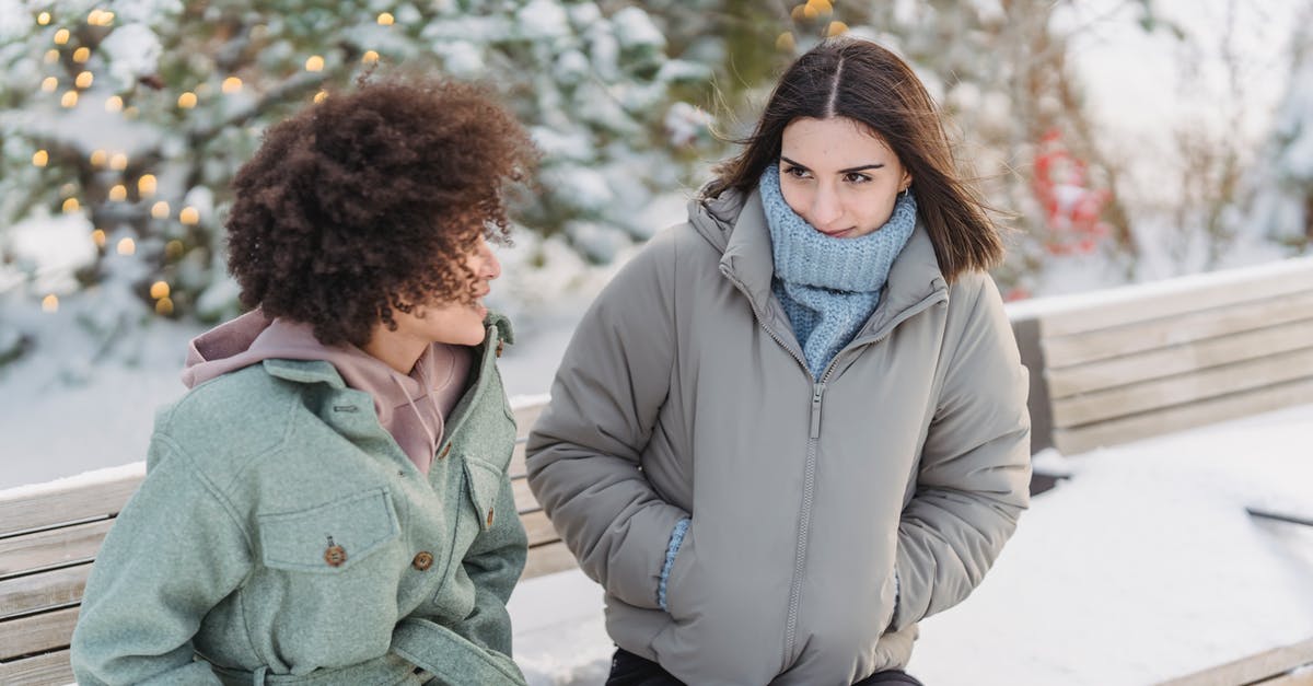 My friend from Texas wants to go on holiday to the UK, but has no passport. Will she need to make one? [closed] - Diverse female friend talking on bench in winter park