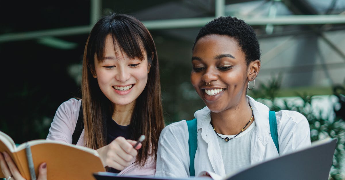My Indian girlfriend studying in Tblisi, Georgia wants to visit me the UK during December. Please help with visa - Multiracial female students studying and talking outside