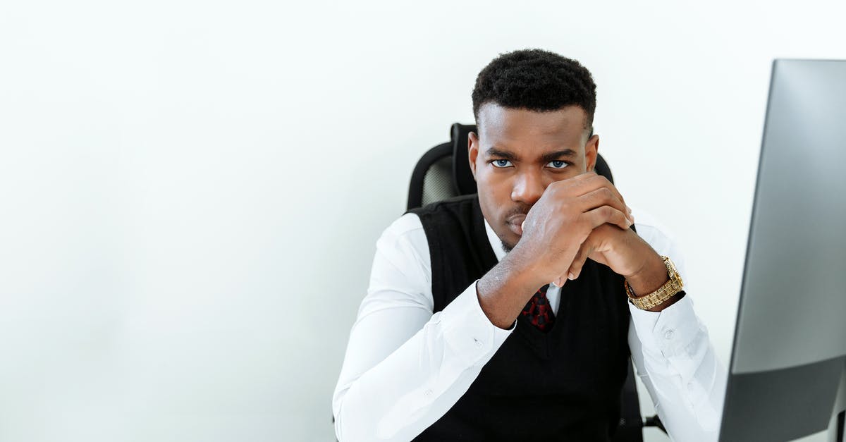 My legal name is Mohamed. Should I be worried about getting denied entry to the US? [closed] - Man in White Dress Shirt Sitting on Black Chair