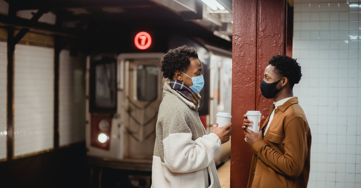 My mom and I are traveling to NYC together. Can we be together at the border control station or will we have to go one after another? - Ethnic man in mask standing on railway platform My mom and I are traveling to NYC together. Can we be together at the border control station or will we have to go one after another? - Ethnic man in mask standing on railway platform