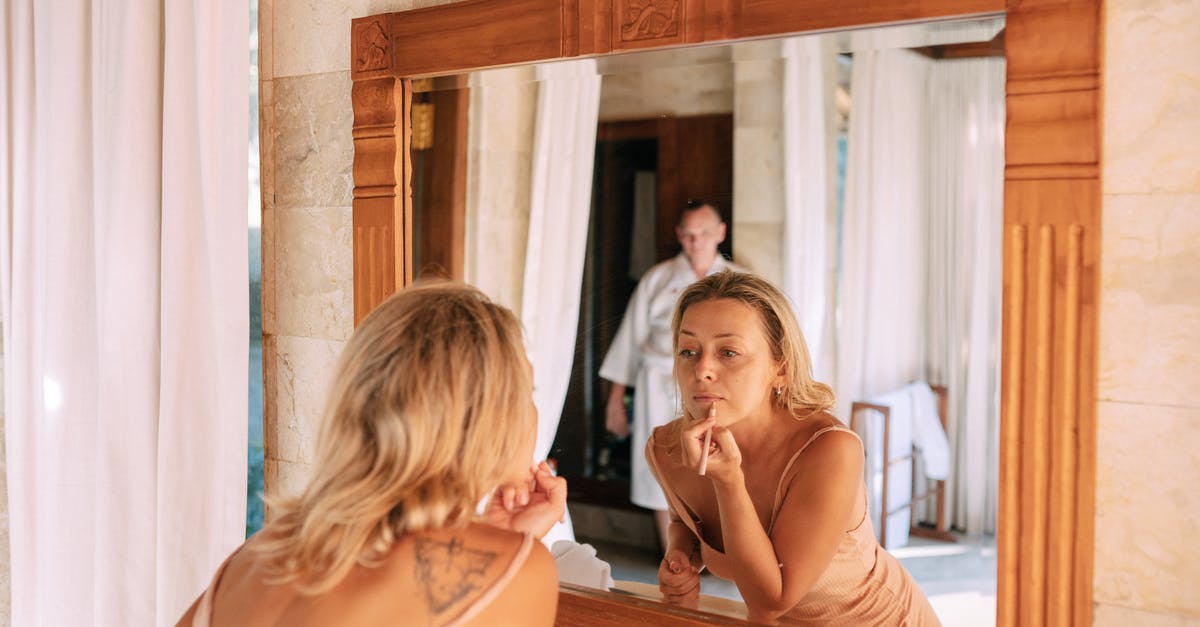 My passport is missing an endorsement. Do I need to get it corrected? - Woman Looking in Mirror in Bathroom Doing Makeup My passport is missing an endorsement. Do I need to get it corrected? - Woman Looking in Mirror in Bathroom Doing Makeup