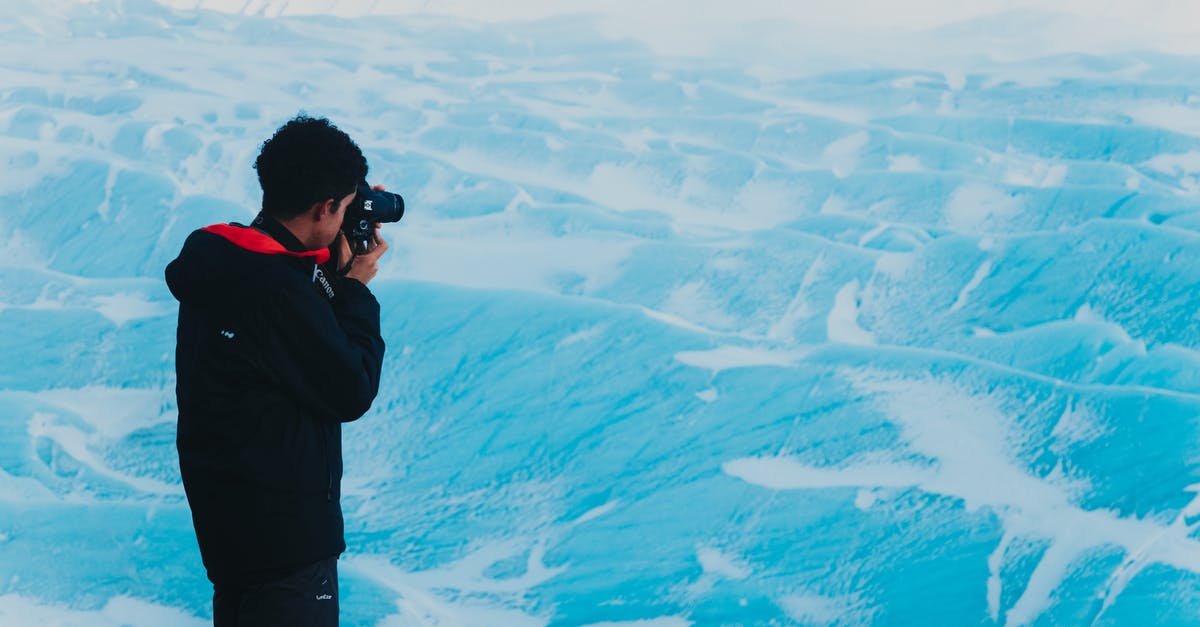 My Schengen tourist visa C is expired and I want to go back in my country [duplicate] - Man taking photo of snowy mountainous terrain