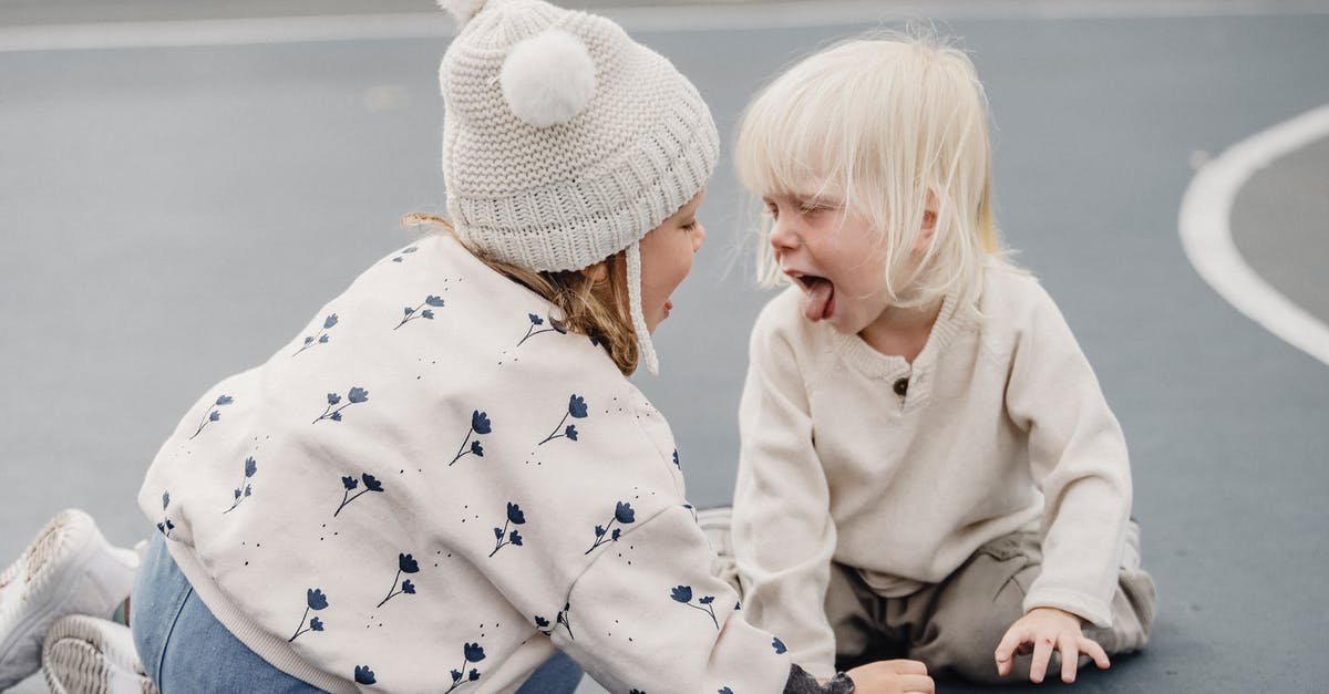 My sister and her husband with two children live in UK: how do I fill out the visa application? [closed] - Side view of cute little girl with hat and playful boy showing tongue sitting on sports ground while having fun against blurred background