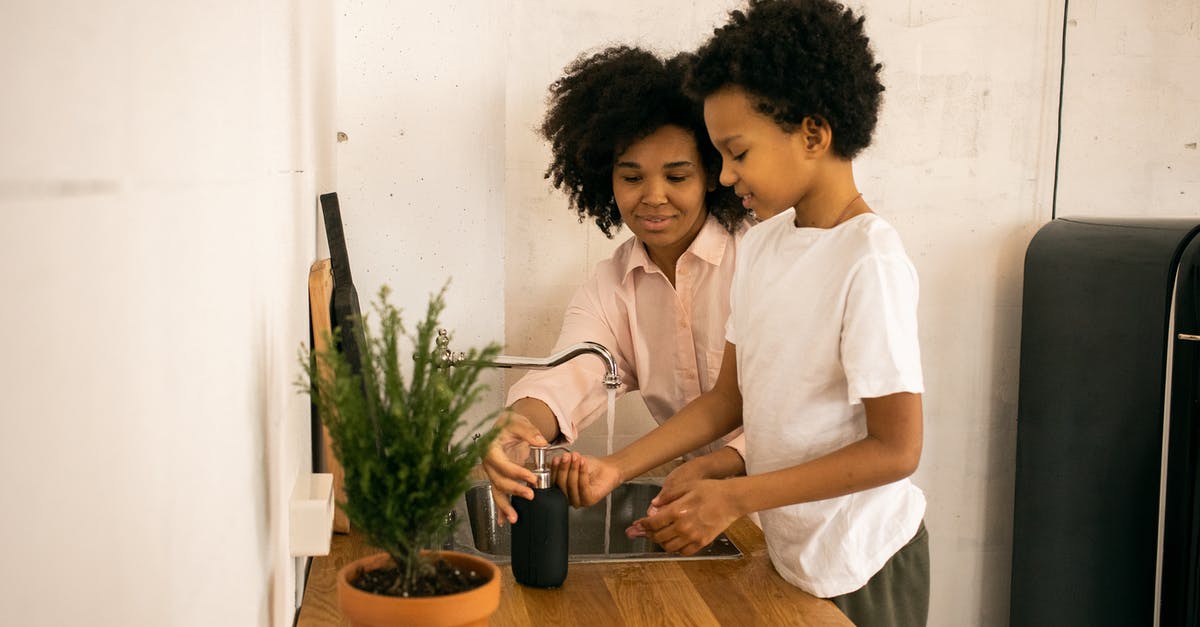 My UK visa has been refused please help I want to re apply [duplicate] - Glad African American mother with son applying soap on hands while washing hands near counter with green potted plant at home