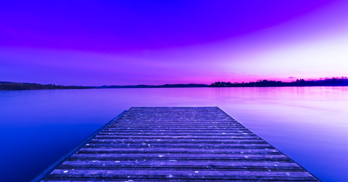 My UK visa is still in processing even though the intended date of travel has already passed. Will I still receive a visa? - Wooden pier above glowing purple lake My UK visa is still in processing even though the intended date of travel has already passed. Will I still receive a visa? - Wooden pier above glowing purple lake