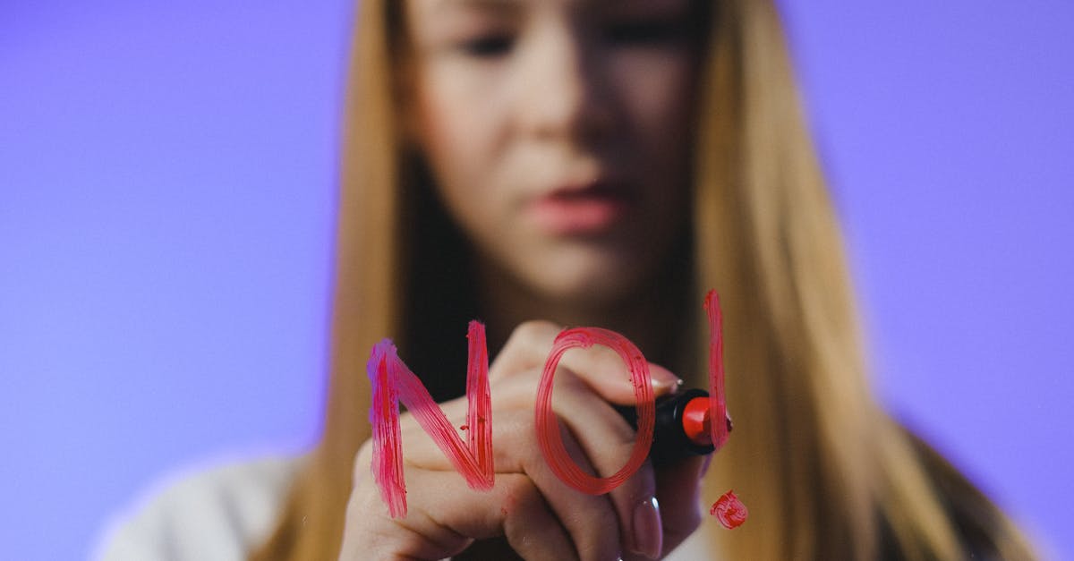 My UK visit visa has been refused twice. Can I re-apply as the refusal was unsatisfactory? [duplicate] - Studio shot of girl writing No word on glass