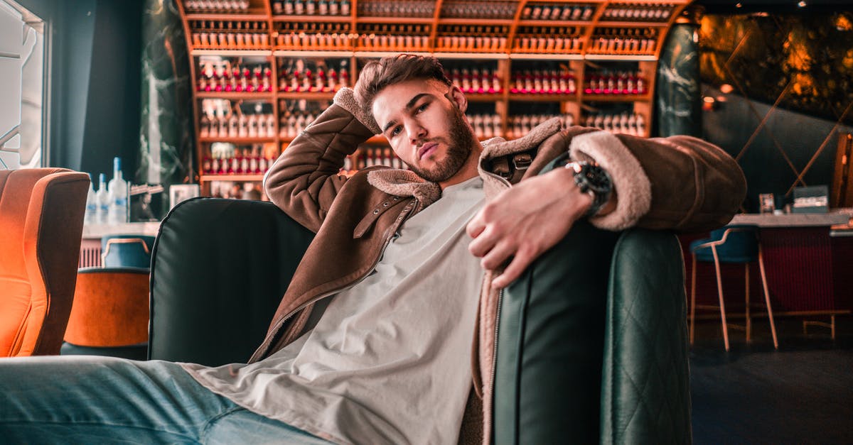 Name of restaurant in Kitzingen, Germany - Man in Brown Coat Lying on Black Leather Couch Name of restaurant in Kitzingen, Germany - Man in Brown Coat Lying on Black Leather Couch