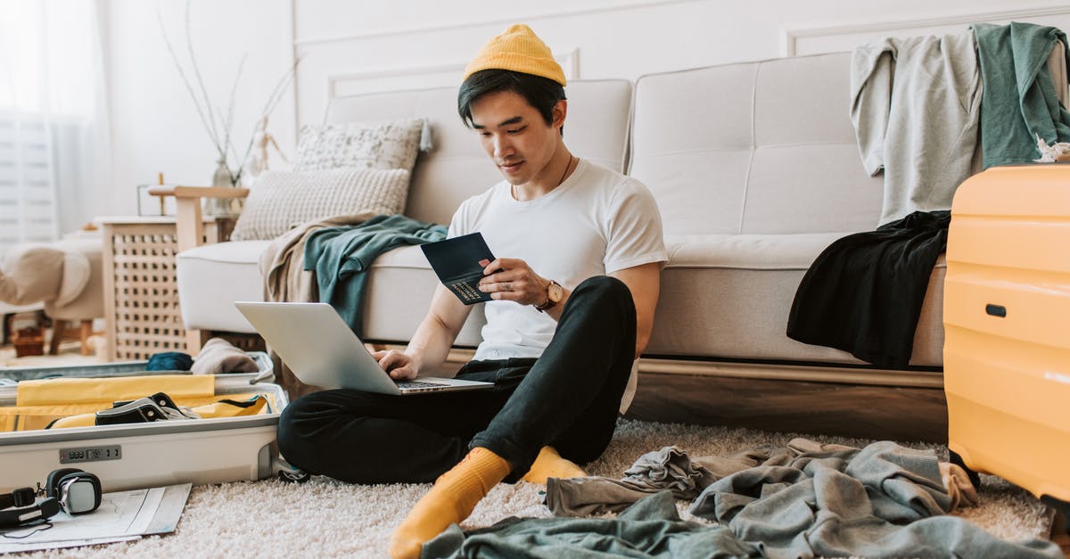 Name spelling is different in passport and educational documents - A Man Using His Laptop in a Messy Living Room Name spelling is different in passport and educational documents - A Man Using His Laptop in a Messy Living Room