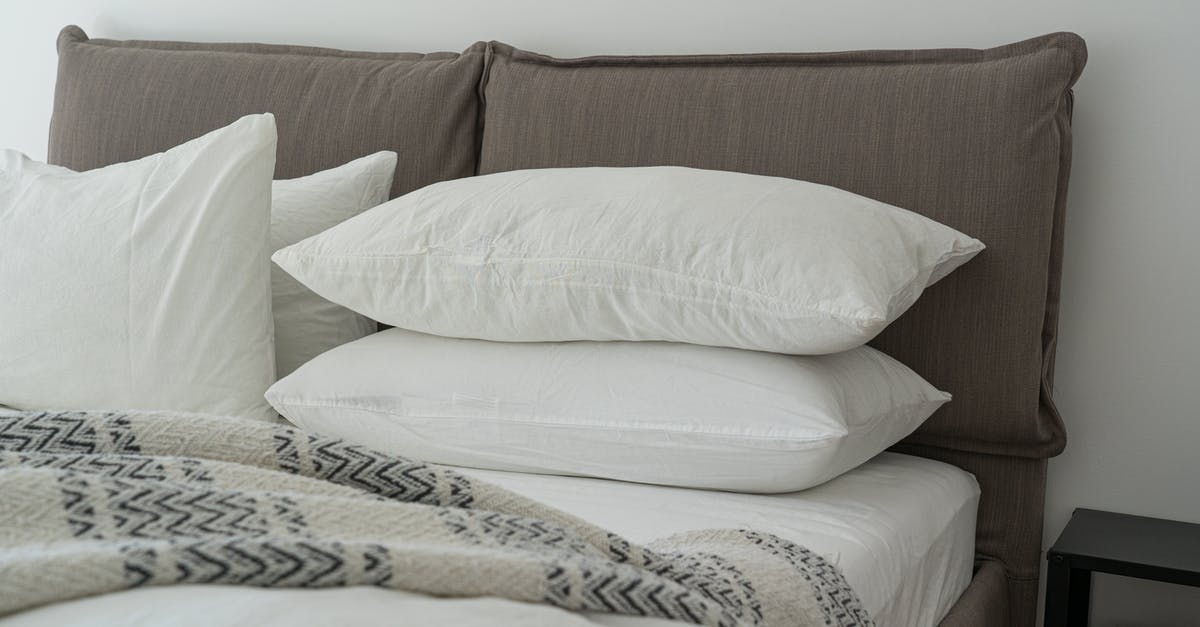 Navigating the layers of American hotel beds: where are you actually supposed to sleep? - White Pillows on a Bed