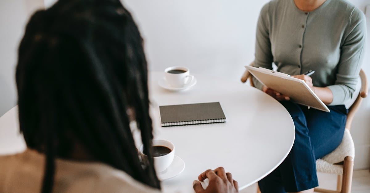 Need advice for UK landing interview (visa-free entry) - Professional ethnic female psychotherapist asking questions to black male patient and taking notes in clipboard while sitting together at table in modern psychotherapy center Need advice for UK landing interview (visa-free entry) - Professional ethnic female psychotherapist asking questions to black male patient and taking notes in clipboard while sitting together at table in modern psychotherapy center