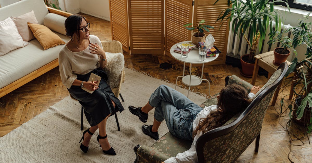 Need advice on problems with Bookings.com and a hotel - Woman in White Long Sleeve Shirt Sitting on Brown Wooden Armchair Need advice on problems with Bookings.com and a hotel - Woman in White Long Sleeve Shirt Sitting on Brown Wooden Armchair