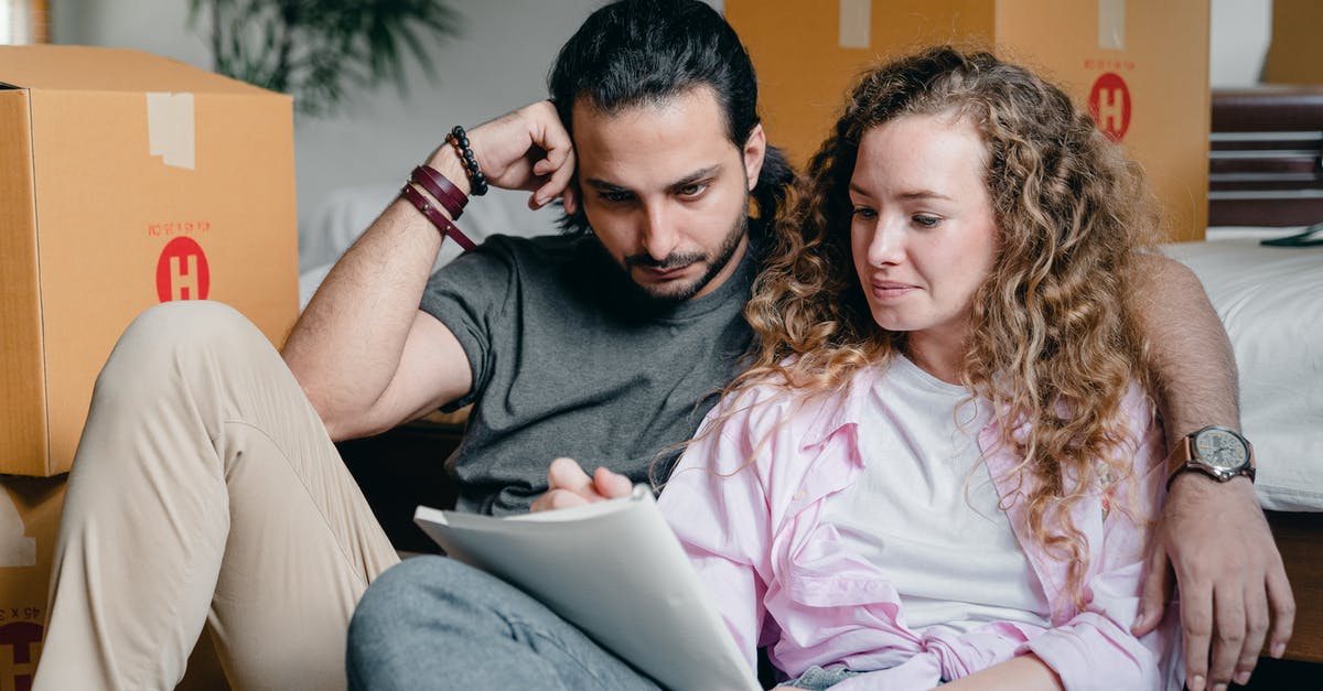 Need experienced comments/thoughts on places in New England [closed] - Pensive male and female in casual clothes sitting together among boxes and writing notes in notebook while leaning on bed