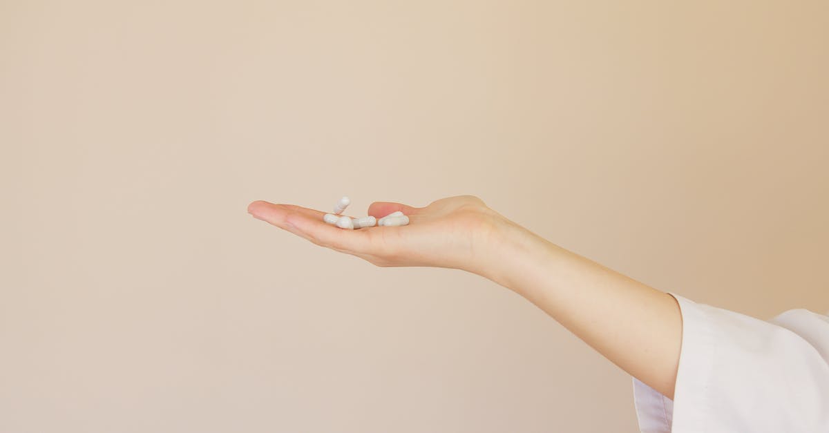 Need malaria medication for Rajasthan in July / August? - Crop female pharmacist with pile of white pills on palm Need malaria medication for Rajasthan in July / August? - Crop female pharmacist with pile of white pills on palm