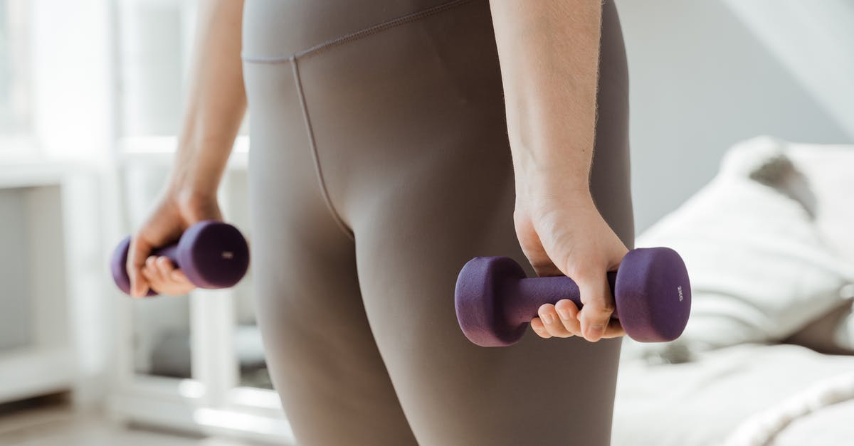 Need to keep ESTA active for Nexus card? - Woman in Gray Tank Top and White Panty Holding Purple Dumbbell