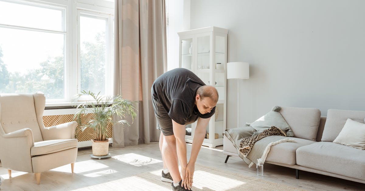 Need to keep ESTA active for Nexus card? - Man in Gray T-shirt and Black Shorts Kneeling on Floor
