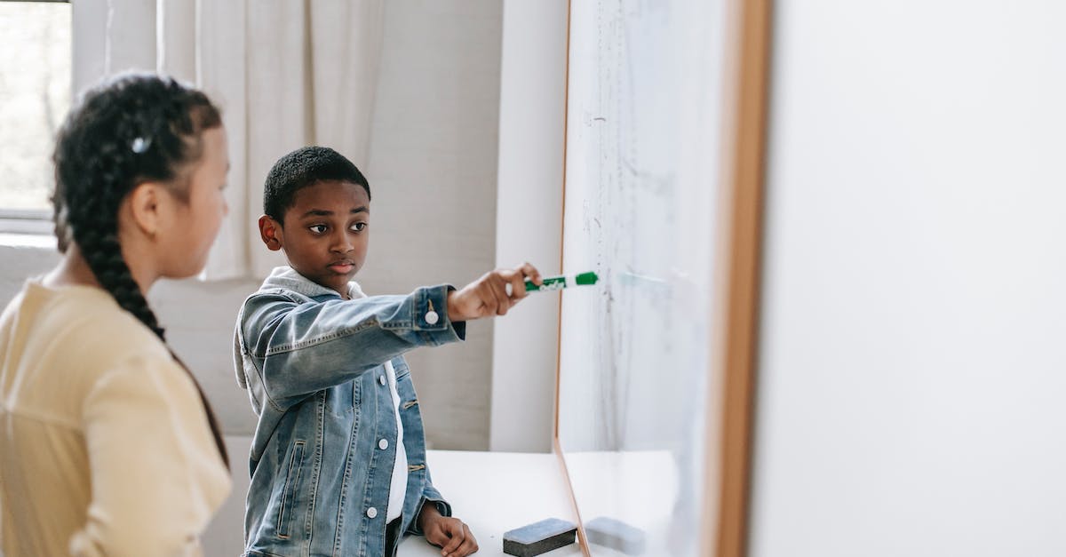 New Orleans ... With kids? - Diverse pupils discussing lesson while pointing at whiteboard New Orleans ... With kids? - Diverse pupils discussing lesson while pointing at whiteboard
