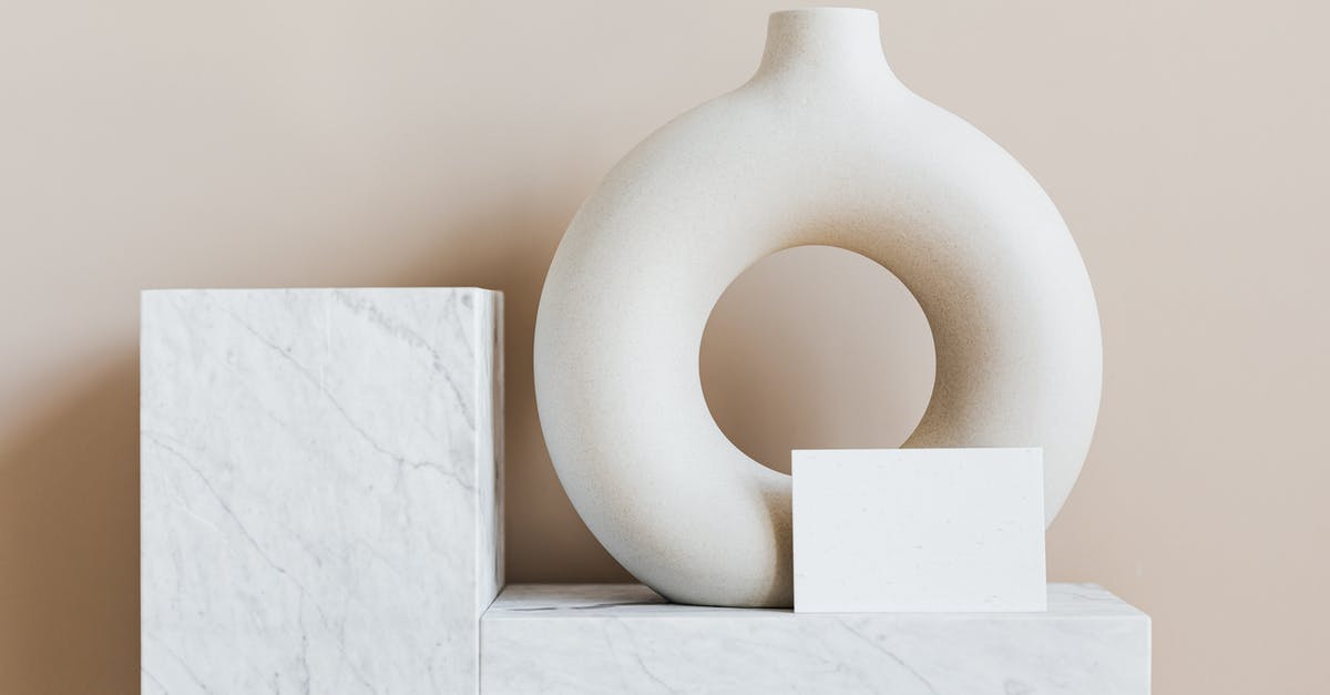 Nexus card interview questions, not living in Canada yet? - Composition of creative white ceramic vase in ring shape with empty postcard placed on white marble shelf against beige wall as home decoration elements or art objects Nexus card interview questions, not living in Canada yet? - Composition of creative white ceramic vase in ring shape with empty postcard placed on white marble shelf against beige wall as home decoration elements or art objects