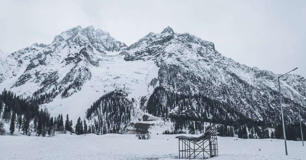 Nigeria to India via Istanbul - Brown Wooden Bench on Snow Covered Ground Near Snow Covered Mountain Nigeria to India via Istanbul - Brown Wooden Bench on Snow Covered Ground Near Snow Covered Mountain