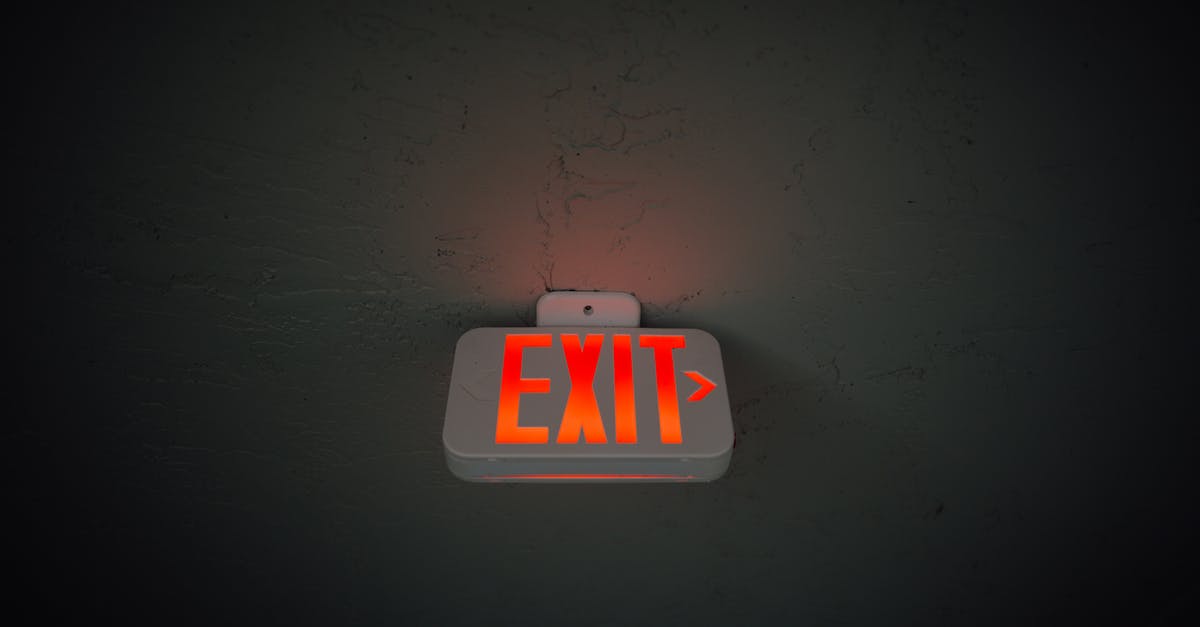 No exit stamp on leaving Schengen area from Budapest to UK - From below of illuminated exit sign hanging on gray concrete ceiling in dark room No exit stamp on leaving Schengen area from Budapest to UK - From below of illuminated exit sign hanging on gray concrete ceiling in dark room