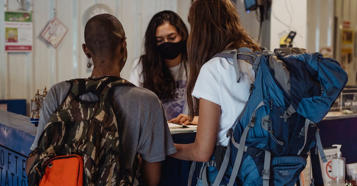 Non greedy hostel or guesthouse in Ulaanbaatar, Mongolia? - Two Women with Travelling Backpacks Checking In On Reception Desk Non greedy hostel or guesthouse in Ulaanbaatar, Mongolia? - Two Women with Travelling Backpacks Checking In On Reception Desk