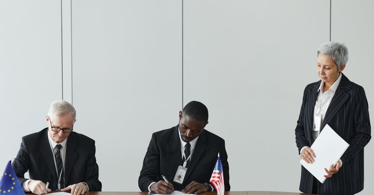 Non-EU citizen working in EU state, can I marry EU national living in another EU state? - Man in Black Suit Sitting Beside Man in Black Suit