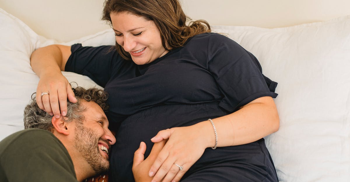 Non-EU visiting UK together with EU spouse and UK marriage certificate - Laughing pregnant couple lying together on bed and having fun Non-EU visiting UK together with EU spouse and UK marriage certificate - Laughing pregnant couple lying together on bed and having fun