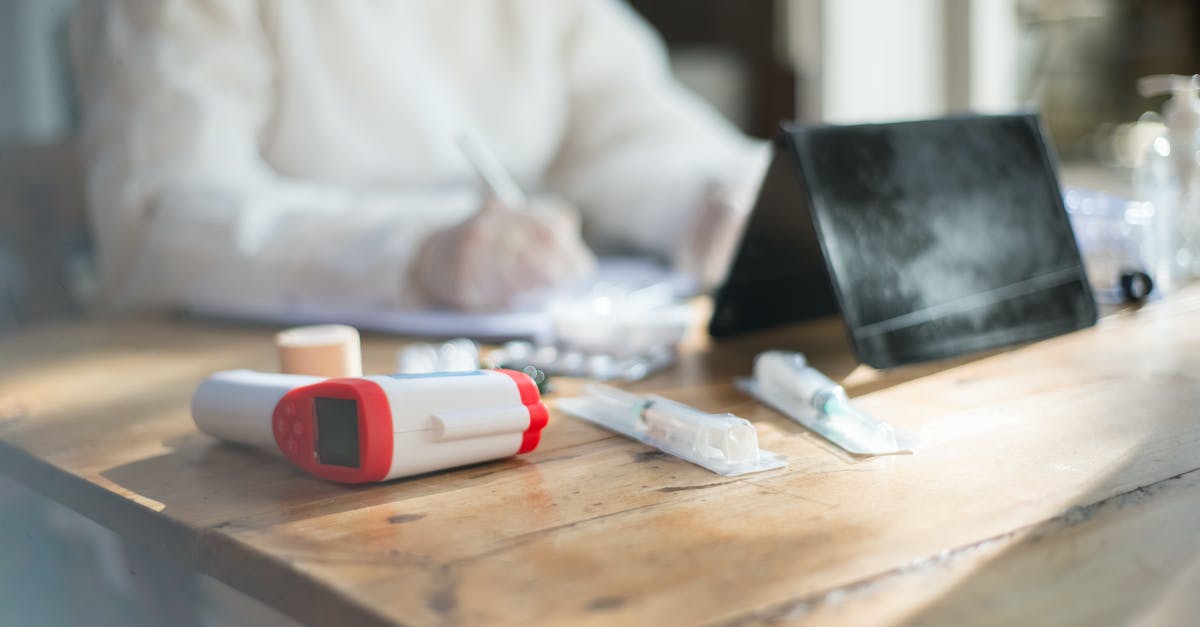 Non-prescription medicines in India and USA - Digital Thermometer and Syringes on the Table Non-prescription medicines in India and USA - Digital Thermometer and Syringes on the Table